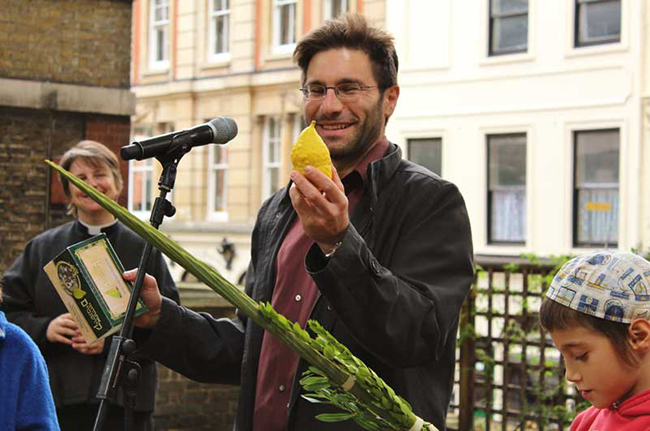 Rabbi Natan speaks at the Harvest/Sukkot celebration, with Rev Lucy Winkett to his right